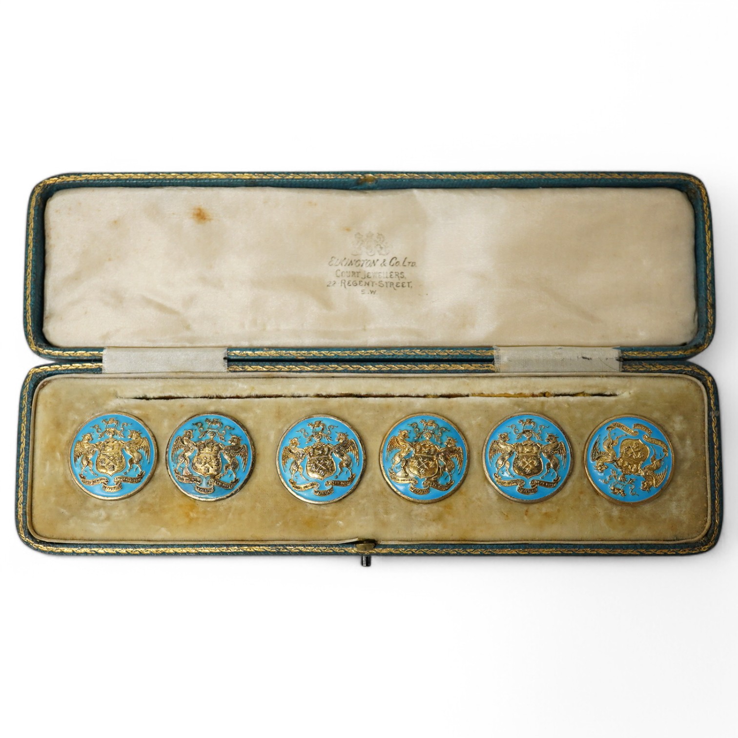 A George V set of 6 blue enamelled silver gilt buttons with armorial and motto 'cumnia subjescisti subpedieue oves et loves', Elkington and Co, Crown Jewellers, Chester 1904, in original case inscribed 'With The Complime